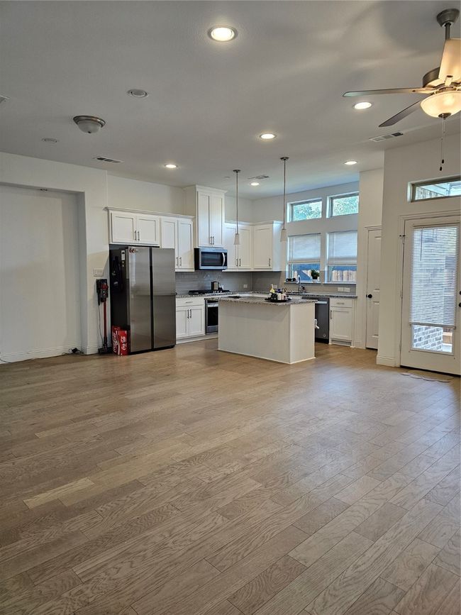 Kitchen featuring refrigerator, range, light wood-style floors, white cabinets, and recessed lighting | Image 5