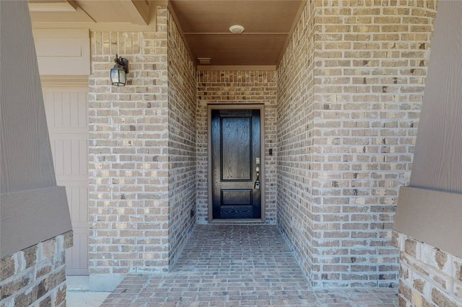 View of exterior entry with brick siding | Image 4