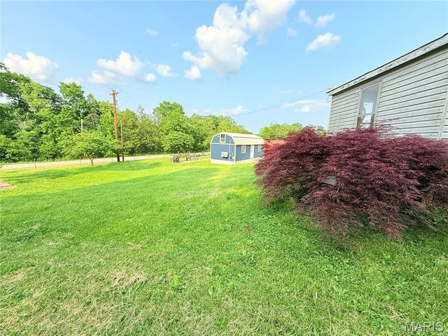 View of green lawn with an outdoor structure | Image 40