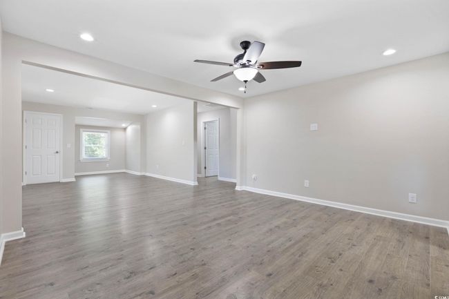 Spare room featuring a ceiling fan, wood finished floors, baseboards, and recessed lighting | Image 12