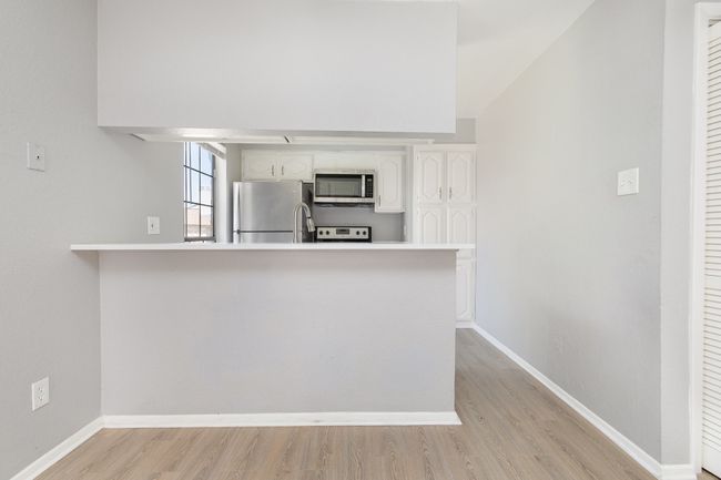 Kitchen has bar seating and room for dinette | Image 10