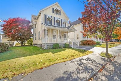 View of front of home featuring a front yard and a porch | Image 1