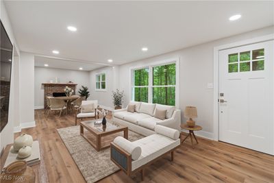 Living room with wood-type flooring and a brick fireplace | Image 3