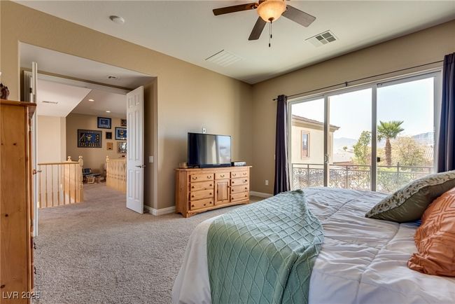 Bedroom featuring baseboards, access to exterior, visible vents, and light colored carpet | Image 52