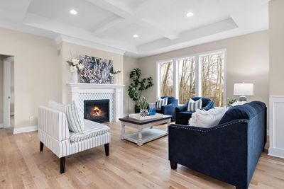 Great room with vaulted & beamed ceiling, real white oak hardwood floors & a pretty fireplace. | Image 2