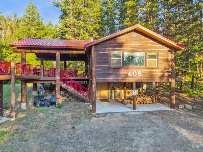 View of front of property with a metal roof and stairway | Image 18