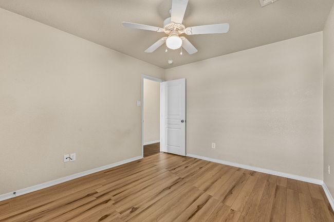 Empty room featuring light wood-type flooring and ceiling fan | Image 27
