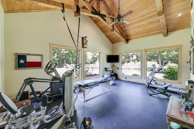 Enjoy your workout while overlooking the beautiful infinity pool and pond. | Image 38