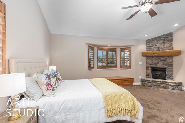 Carpeted bedroom featuring recessed lighting, a fireplace, baseboards, and a ceiling fan | Image 25