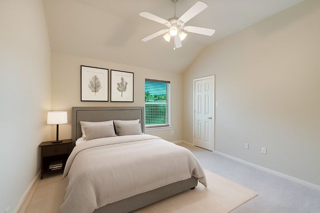 Bedroom featuring light carpet, vaulted ceiling, and a ceiling fan | Image 30