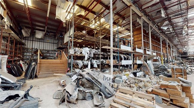 Misc room with lofted ceiling and concrete flooring | Image 31