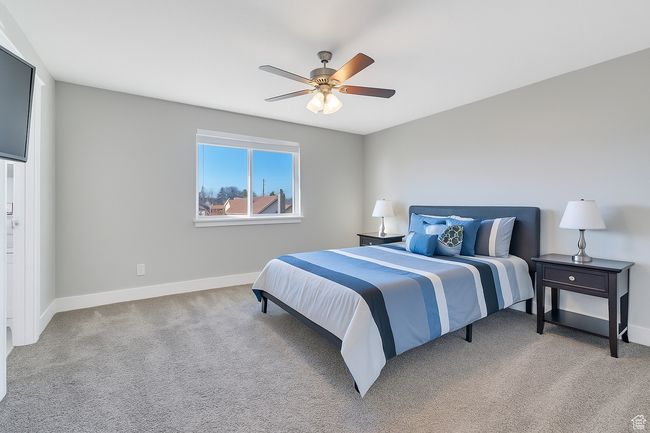 Bedroom featuring light colored carpet and a ceiling fan | Image 13