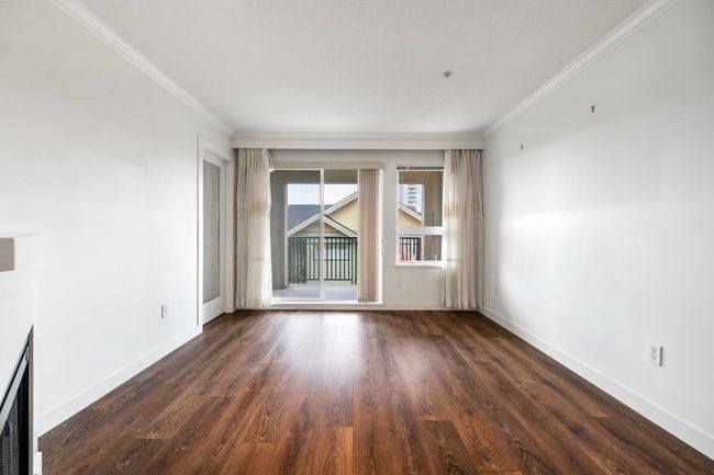 Empty room featuring ornamental molding and dark wood finished floors | Image 5