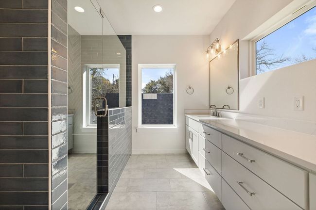 Primary Bathroom with recessed lighting, baseboards, tiled shower, and vanity | Image 29