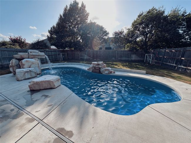 View of pool featuring a fenced backyard and a patio area | Image 30