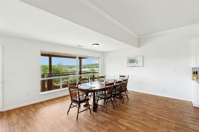 Dining space with ornamental molding and wood finished floors | Image 13