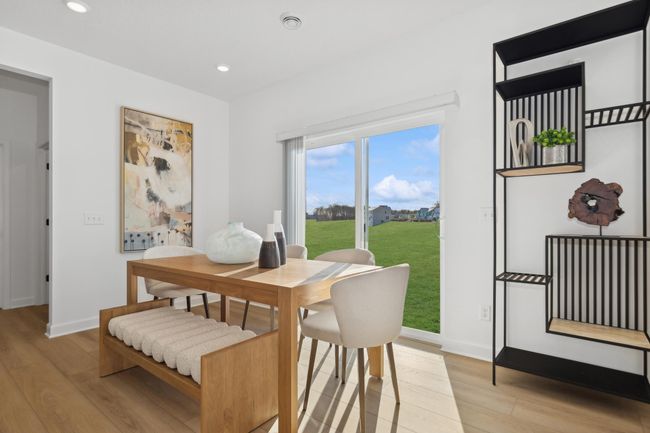 (Photo of a decorated model, actual homes finishes will vary) Soaked in natural sunlight, the homes eat-in dining room has ample room for a dining table located in the heart of the home. | Image 4