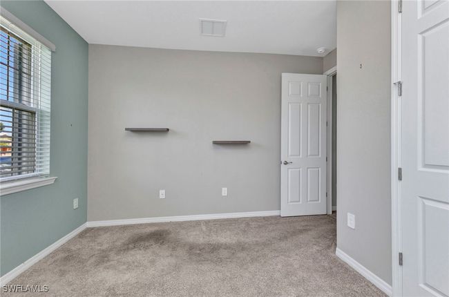 Unfurnished bedroom featuring carpet, visible vents, and baseboards | Image 17