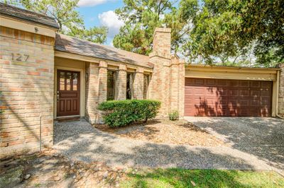 A charming patio home showcasing mature trees and elegant brickwork, exuding a classic mid-century modern vibe with timeless appeal. | Image 2