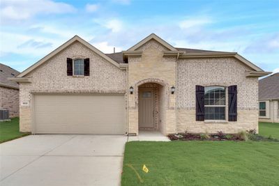 View of front of home featuring cooling unit, a garage, and a front lawn | Image 1