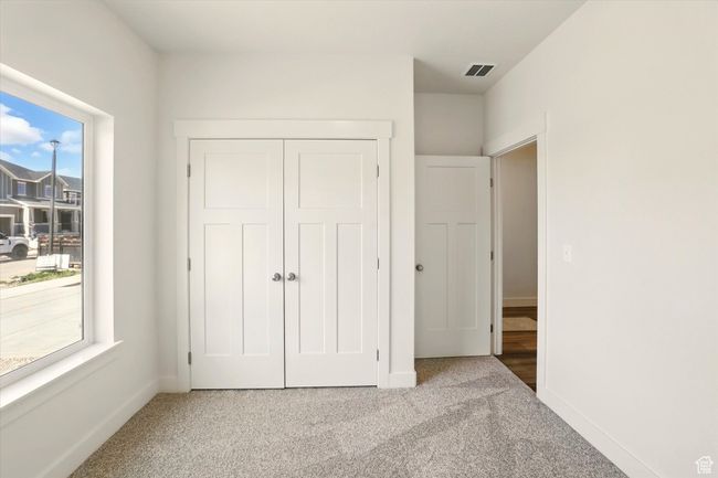 Unfurnished bedroom featuring carpet, a closet, and baseboards | Image 29