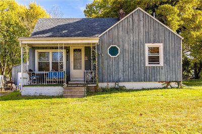 View of front facade with a porch and a front lawn | Image 1