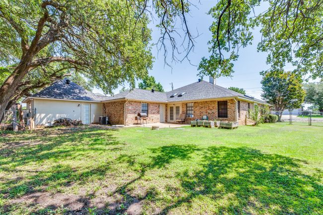 Open patio and large grassed yard. | Image 25