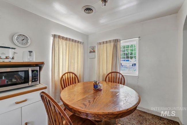 Carpeted dining space with baseboards | Image 10