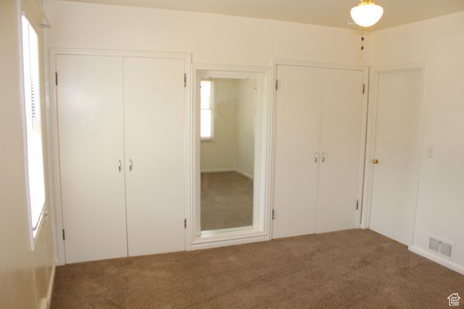 Unfurnished bedroom featuring multiple closets and carpet flooring | Image 31