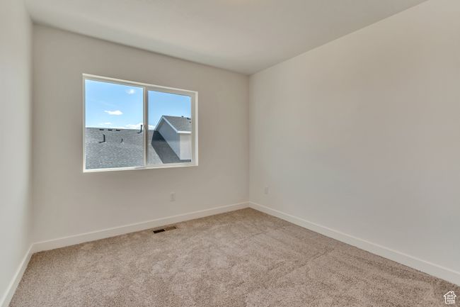 Carpeted empty room with visible vents and baseboards | Image 9