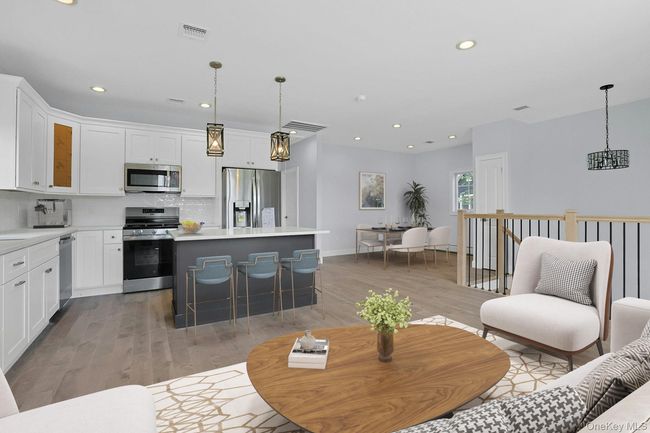 Living area with light wood-style floors, recessed lighting, and a chandelier | Image 6