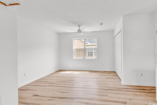 Interior space featuring visible vents, a ceiling fan, light wood-style flooring, and baseboards | Image 6