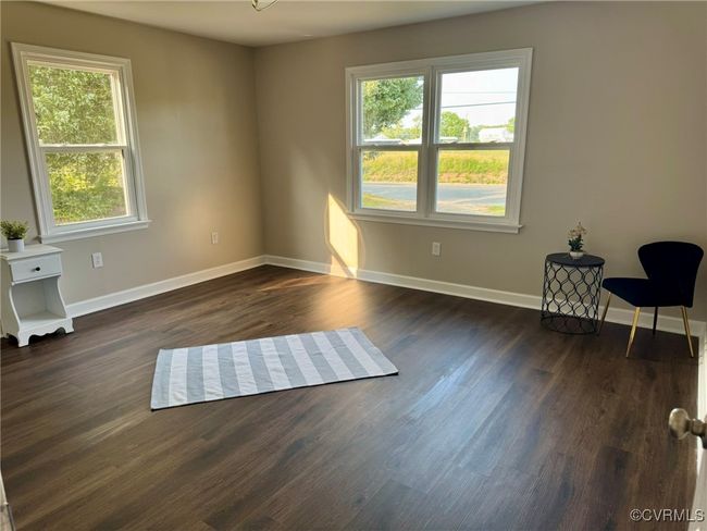 Unfurnished room with baseboards and dark wood-type flooring | Image 18