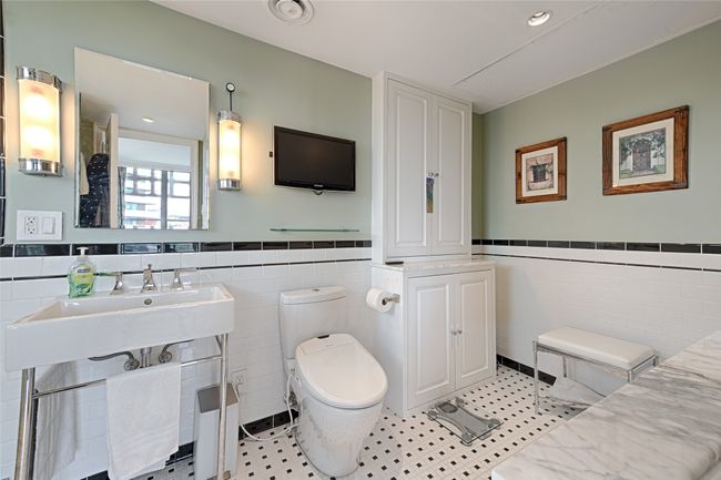 Primary bath with tile walls and wainscoting | Image 13