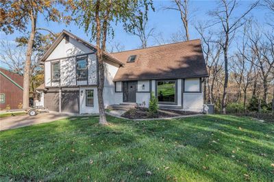 View of front facade featuring a front yard and a garage | Image 2