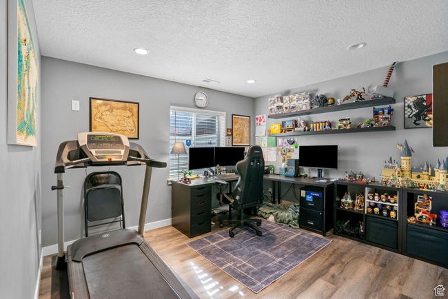Home office with recessed lighting, wood finished floors, a textured ceiling, and baseboards | Image 24