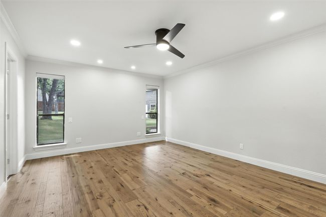 Empty room featuring ornamental molding, a ceiling fan, wood finished floors, and recessed lighting | Image 22
