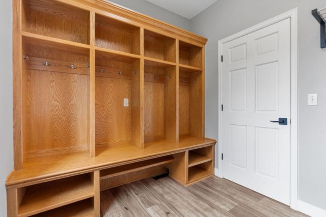 The laundry room includes built-in lockers, washer, dryer, and storage. | Image 22