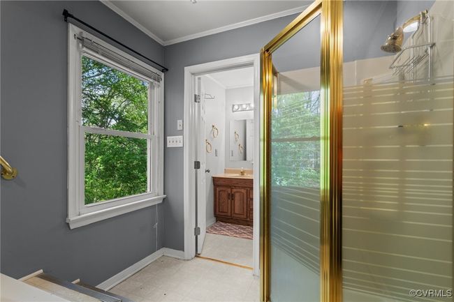 Doorway with a healthy amount of sunlight, crown molding, baseboards, and light floors | Image 23