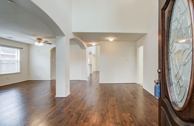 Gleaming Hicklory hardwood floors span from the front door all the way through the family room. | Image 5