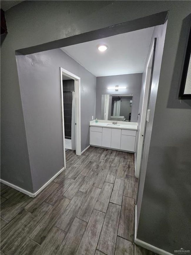 Full bath featuring wood finished floors, vanity, and baseboards | Image 9
