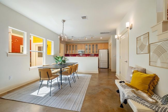 The dining area offers an ideal space for gatherings, with a seamless flow from the living room and an abundance of natural light that creates a warm, inviting atmosphere for every meal | Image 9