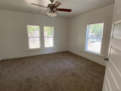 Spare room with dark colored carpet and ceiling fan | Image 3