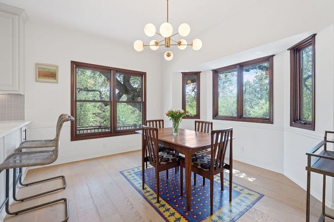 Dining space featuring plenty of natural light, light wood finished floors, and a chandelier | Image 16
