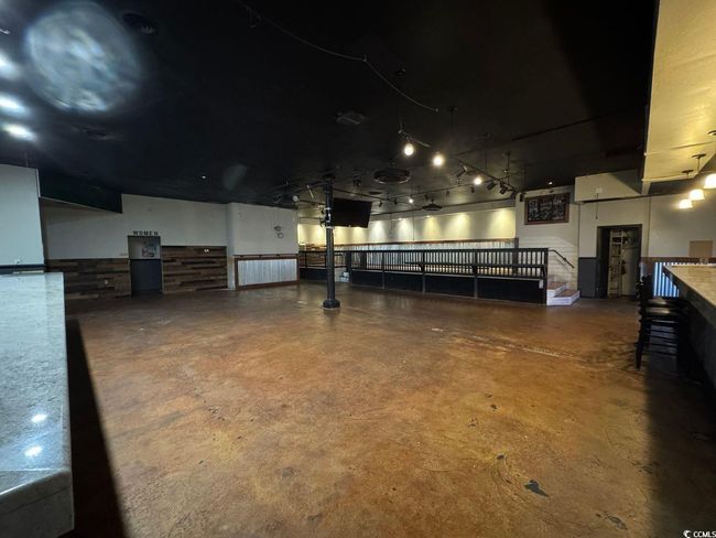 Miscellaneous room featuring finished concrete floors and a garage | Image 5