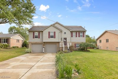 Split foyer home featuring a garage and a front yard | Image 2