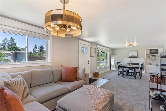 Living room featuring a chandelier and carpet | Image 8
