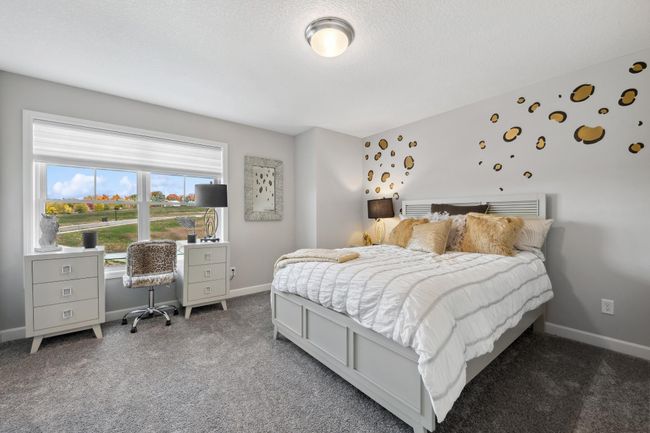 (Photo of decorated model, actual home's finishes will vary) The two secondary bedrooms provide comfort and privacy. | Image 17