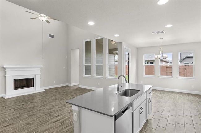 Kitchen with dishwasher, a sink, wood finish floors, a ceiling fan, and recessed lighting | Image 12