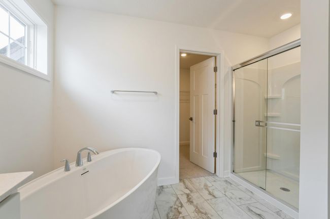 Photo is of the actual home. Another view of the primary bath. | Image 9